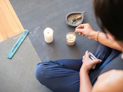 Peaceful setting with incense and yoga accessories.
